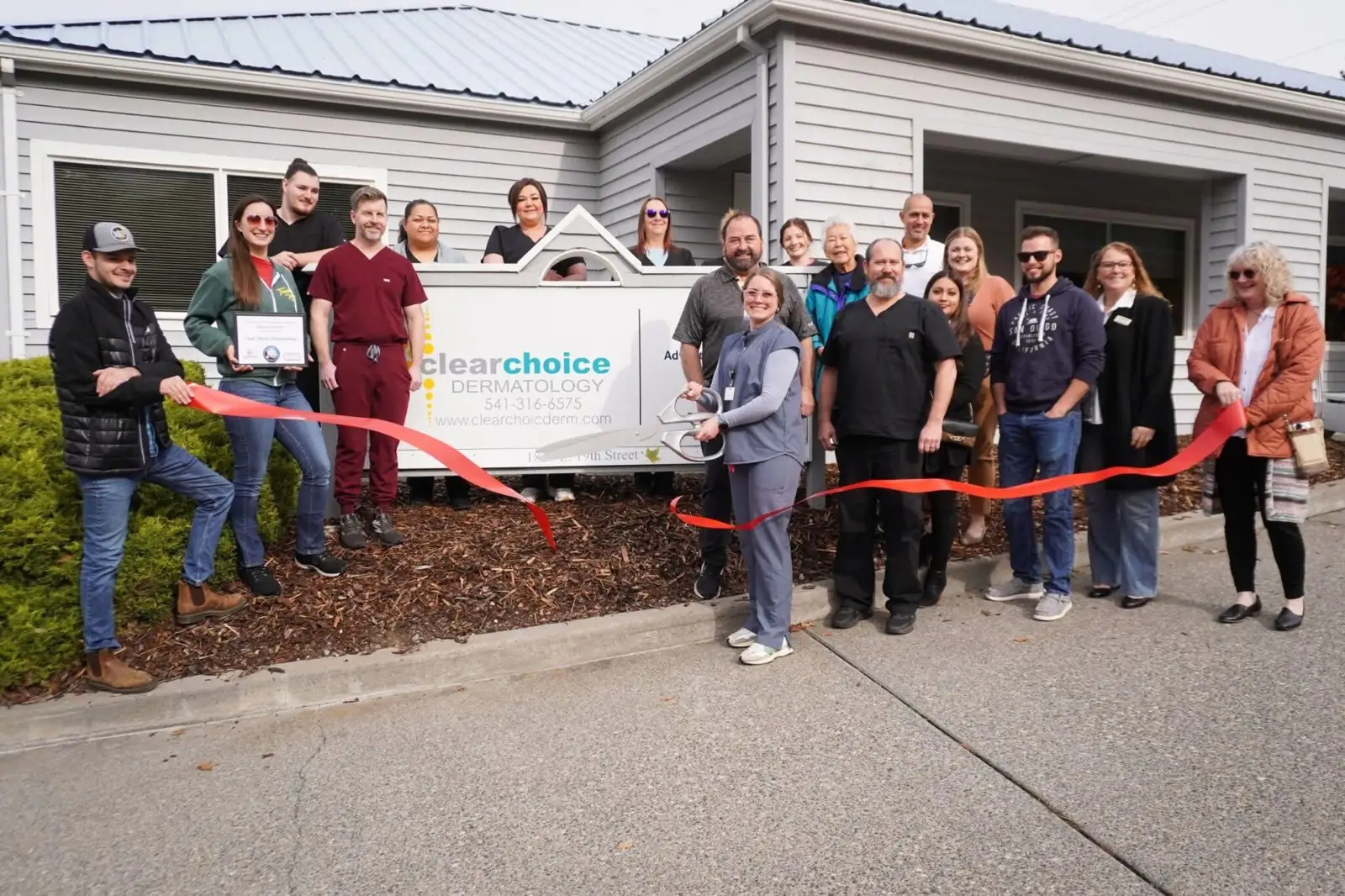 Clear Choice Dermatology team celebrating a Chamber of Commerce ribbon cutting outside our clinic in The Dalles, Oregon
